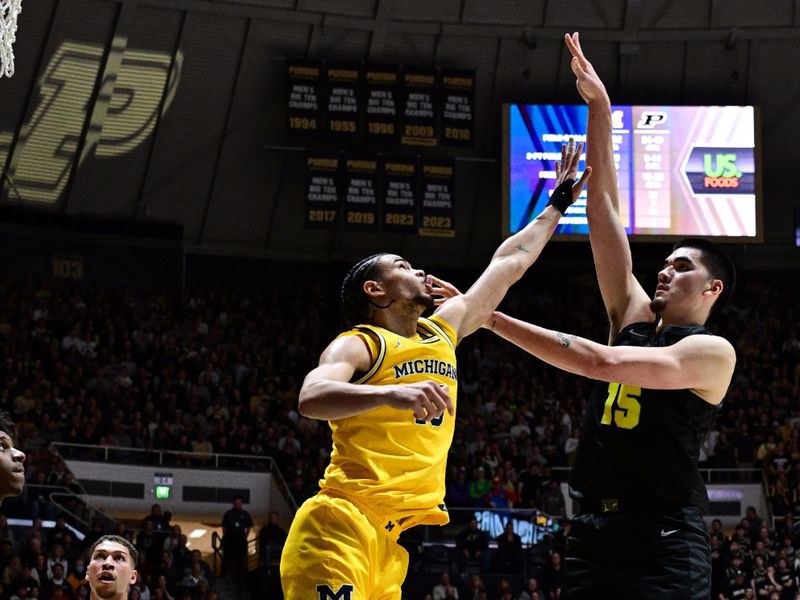 Jan 23, 2024; West Lafayette, Indiana, USA; Purdue Boilermakers center Zach Edey (15) shoots the ball over Michigan Wolverines forward Olivier Nkamhoua (13) during the second half at Mackey Arena. Mandatory Credit: Marc Lebryk-USA TODAY Sports