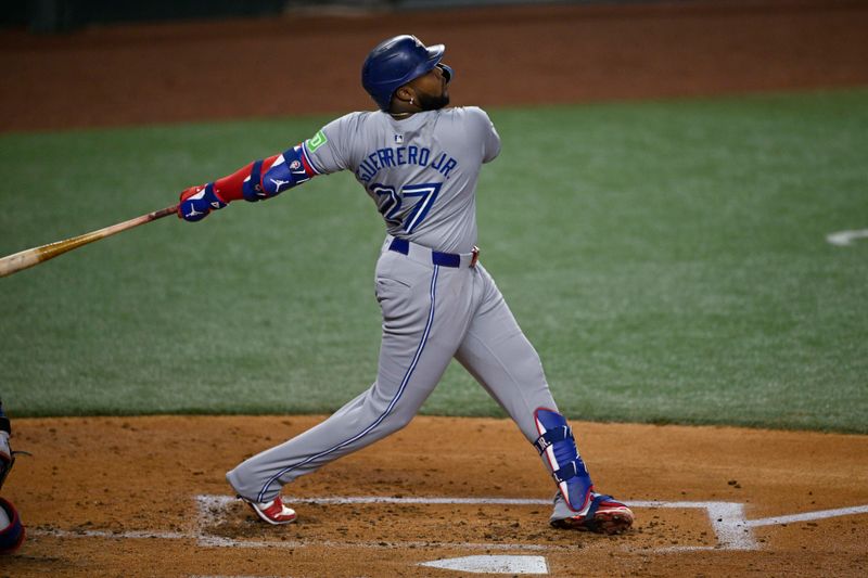 Sep 17, 2024; Arlington, Texas, USA; Toronto Blue Jays first baseman Vladimir Guerrero Jr. (27) hits a double and drives in a run against the Texas Rangers during the second inning at Globe Life Field. Mandatory Credit: Jerome Miron-Imagn Images