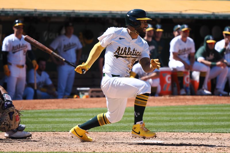 May 23, 2024; Oakland, California, USA; Oakland Athletics third baseman Abraham Toro (31) hits an RBI single against the Colorado Rockies during the eleventh inning at Oakland-Alameda County Coliseum. Mandatory Credit: Kelley L Cox-USA TODAY Sports