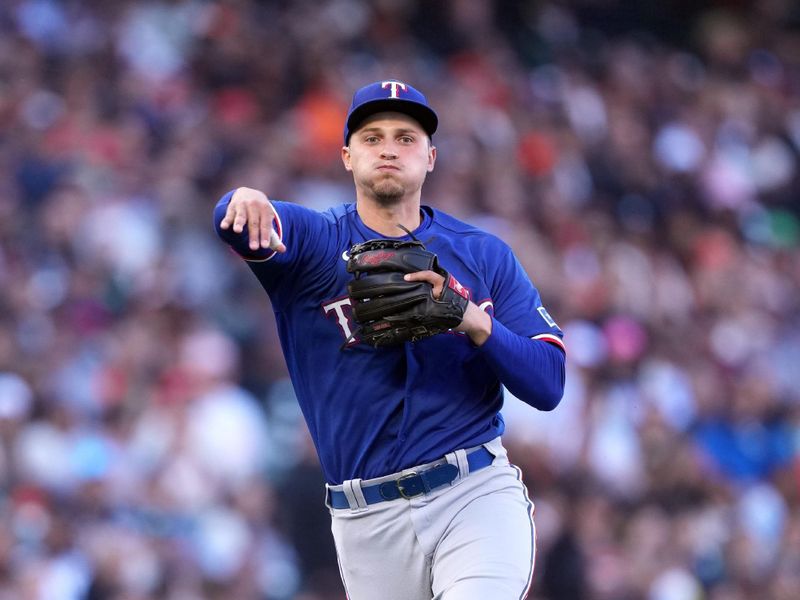 Aug 12, 2023; San Francisco, California, USA; Texas Rangers shortstop Corey Seager (5) throws the ball to first base during the third inning against the San Francisco Giants at Oracle Park. Mandatory Credit: Darren Yamashita-USA TODAY Sports