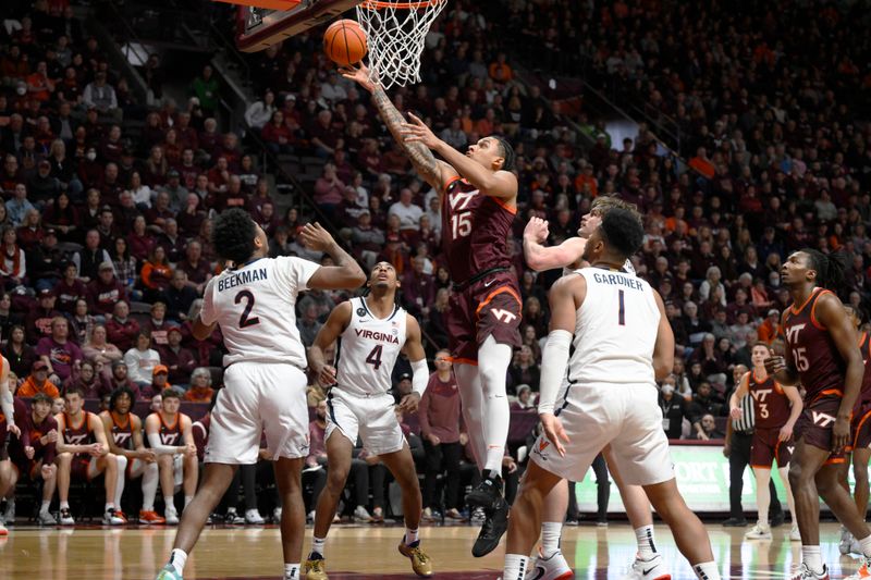 Feb 4, 2023; Blacksburg, Virginia, USA; Virginia Tech Hokies center Lynn Kidd (15) drives to basket between several Virginia Cavalier defenders at Cassell Coliseum. Mandatory Credit: Lee Luther Jr.-USA TODAY Sports