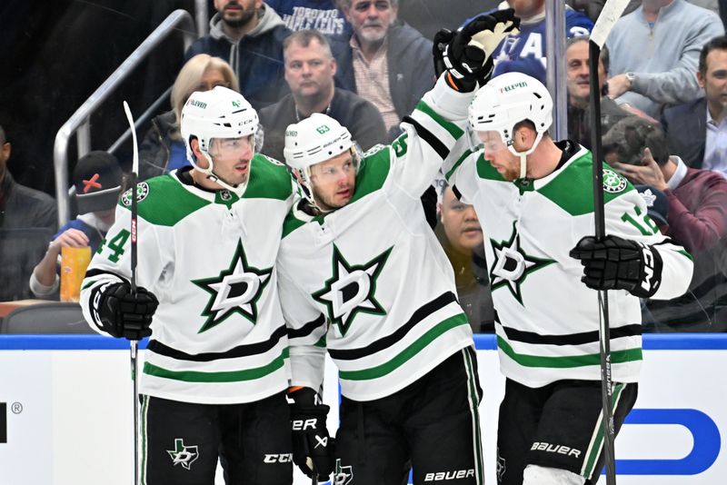 Feb 7, 2024; Toronto, Ontario, CAN; Dallas Stars forward Evgenii Dadonov (63) celebrates with defenseman ZJoel Hanley (44) and forward Radek Faksa (12) after scoring against the Toronto Maple Leafs in the first period at Scotiabank Arena. Mandatory Credit: Dan Hamilton-USA TODAY Sports