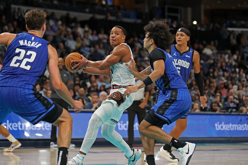 MEMPHIS, TENNESSEE - OCTOBER 26: Desmond Bane #22 of the Memphis Grizzlies looks to pass against Franz Wagner #22 of the Orlando Magic during the second half at FedExForum on October 26, 2024 in Memphis, Tennessee. NOTE TO USER: User expressly acknowledges and agrees that, by downloading and or using this photograph, User is consenting to the terms and conditions of the Getty Images License Agreement. (Photo by Justin Ford/Getty Images)