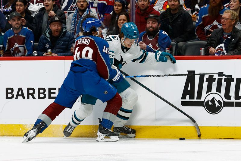 Mar 6, 2025; Denver, Colorado, USA; Colorado Avalanche defenseman Samuel Girard (49) and San Jose Sharks center Macklin Celebrini (71) battle for the puck in the first period at Ball Arena. Mandatory Credit: Isaiah J. Downing-Imagn Images