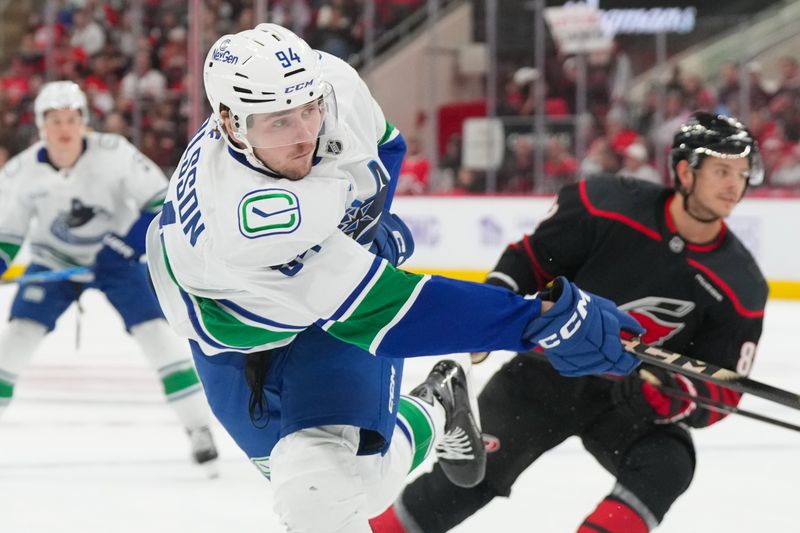 Nov 14, 2025; Raleigh, North Carolina, USA;  Vancouver Canucks center Linus Karlsson (94) takes a shot against the Carolina Hurricanes during the second period at Lenovo Center. Mandatory Credit: James Guillory-Imagn Images