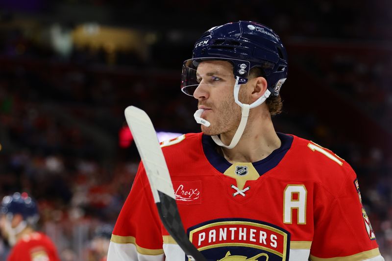 Nov 14, 2024; Sunrise, Florida, USA; Florida Panthers left wing Matthew Tkachuk (19) looks on against the New Jersey Devils during the second period at Amerant Bank Arena. Mandatory Credit: Sam Navarro-Imagn Images