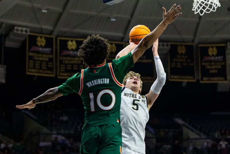 Jan 13, 2026; South Bend, Indiana, USA; Notre Dame Fighting Irish guard Cole Certa (5) drives to the basket as Miami (FL) Hurricanes guard Tru Washington (10) defends during the first half at Purcell Pavilion at the Joyce Center. Mandatory Credit: Michael Caterina-Imagn Images