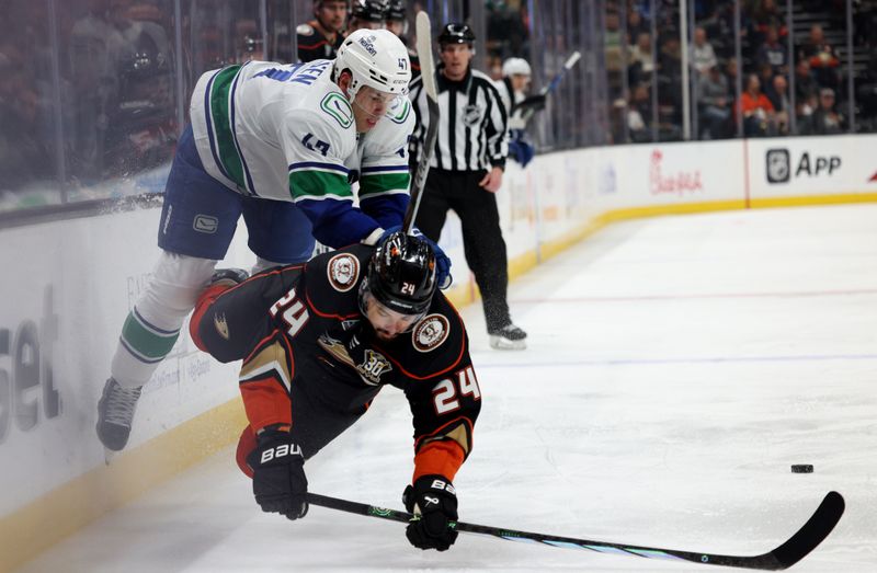 Mar 3, 2024; Anaheim, California, USA; Vancouver Canucks defenseman Noah Juulsen (47) checks Anaheim Ducks center Bo Groulx (24) during the first period at Honda Center. Mandatory Credit: Jason Parkhurst-USA TODAY Sports