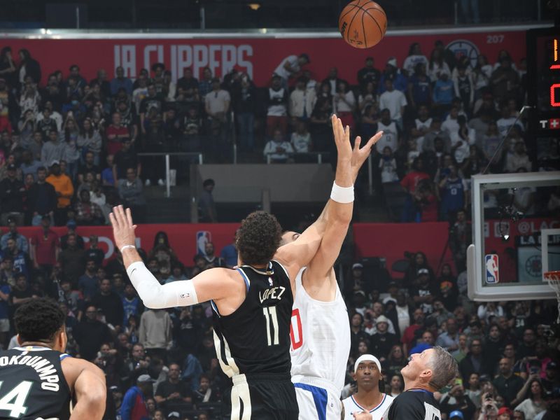 LOS ANGELES, CA - MARCH 10: Brook Lopez #11 of the Milwaukee Bucks and Ivica Zubac #40 of the LA Clippers go for the opening tip-off on March 10, 2024 at Crypto.Com Arena in Los Angeles, California. NOTE TO USER: User expressly acknowledges and agrees that, by downloading and/or using this Photograph, user is consenting to the terms and conditions of the Getty Images License Agreement. Mandatory Copyright Notice: Copyright 2024 NBAE (Photo by Andrew D. Bernstein/NBAE via Getty Images)