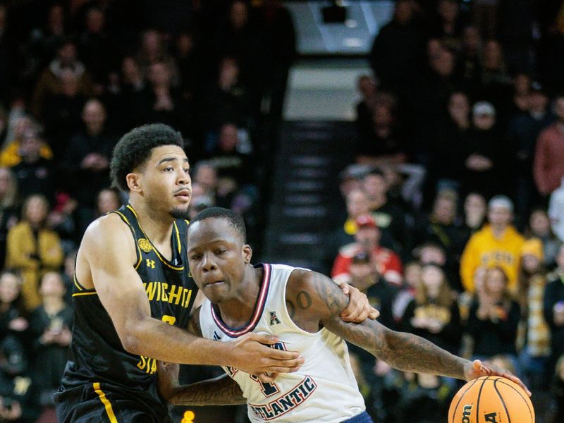 Feb 11, 2024; Wichita, Kansas, USA; Florida Atlantic Owls guard Johnell Davis (1) drives around Wichita State Shockers forward Isaac Abidde (5) during the second half at Charles Koch Arena. Mandatory Credit: William Purnell-USA TODAY Sports