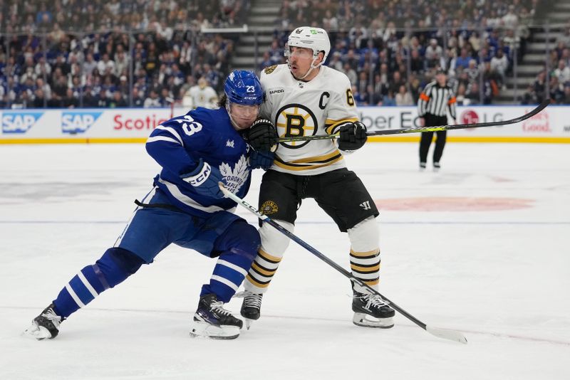 Apr 24, 2024; Toronto, Ontario, CAN; Toronto Maple Leafs forward Matthew Knies (23) battles with Boston Bruins forward Brad Marchand (63) during the second period of game three of the first round of the 2024 Stanley Cup Playoffs at Scotiabank Arena. Mandatory Credit: John E. Sokolowski-USA TODAY Sports