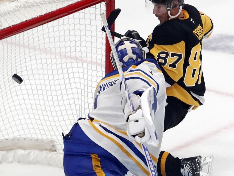 Oct 16, 2024; Pittsburgh, Pennsylvania, USA; Pittsburgh Penguins center Sidney Crosby (87) scores a game winning power play goal against Buffalo Sabres goaltender Ukko-Pekka Luukkonen (1) in overtime at PPG Paints Arena. Mandatory Credit: Charles LeClaire-Imagn Images