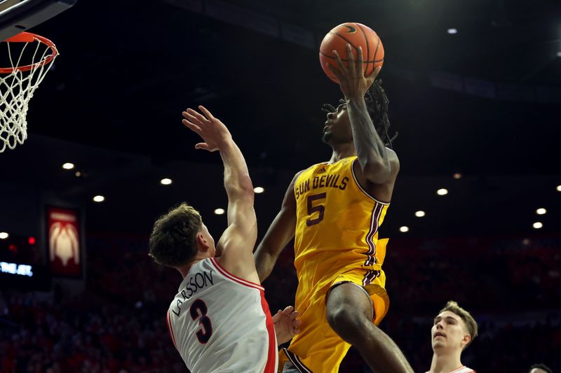 Feb 17, 2024; Tucson, Arizona, USA; Arizona State Sun Devils guard Jamiya Neal (5) shoots a basket against Arizona Wildcats guard Pelle Larsson (3) during the first half at McKale Center. Mandatory Credit: Zachary BonDurant-USA TODAY Sports