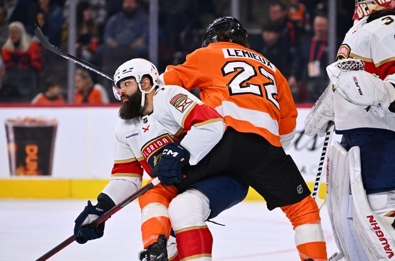 Mar 21, 2023; Philadelphia, Pennsylvania, USA; Florida Panthers defenseman Radko Gudas (7) battles for position with Philadelphia Flyers left wing Brendan Lemieux (22) in the first period at Wells Fargo Center. Mandatory Credit: Kyle Ross-USA TODAY Sports