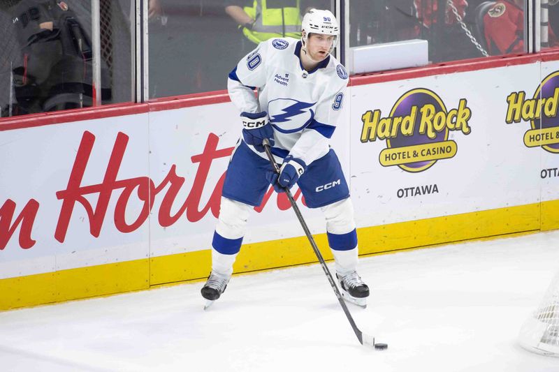 Oct 19, 2024; Ottawa, Ontario, CAN; Tampa Bay Lightning defenseman Janis Moser (90) controls the puck in the third period against the Ottawa Senators at the Canadian Tire Centre. Mandatory Credit: Marc DesRosiers-Imagn Images