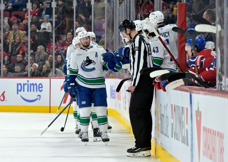 Jan 6, 2025; Montreal, Quebec, CAN; Vancouver Canucks forward J.T. Miller (9) celebrates with teammates after scoring a goal against the Montreal Canadiens during the second period at the Bell Centre. Mandatory Credit: Eric Bolte-Imagn Images