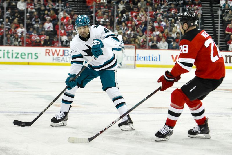 Nov 10, 2024; Newark, New Jersey, USA; San Jose Sharks defenseman Cody Ceci (4) skates with the puck against New Jersey Devils right wing Timo Meier (28) during the first period at Prudential Center. Mandatory Credit: John Jones-Imagn Images