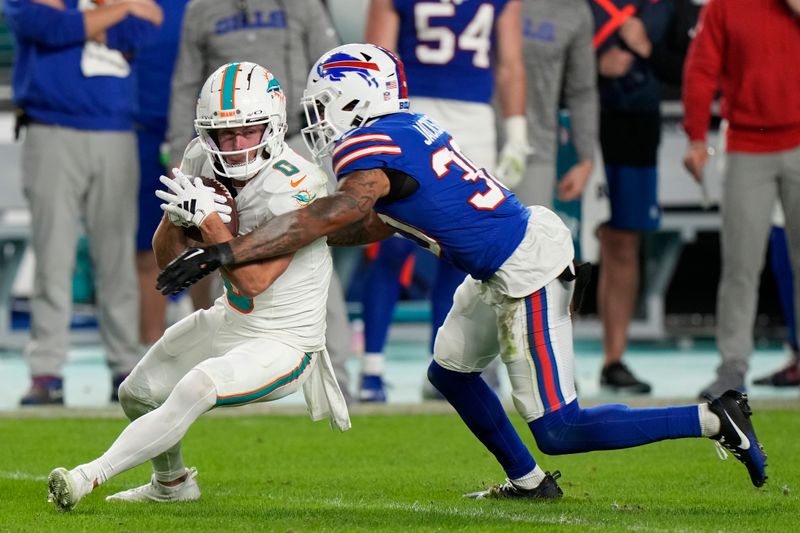 Buffalo Bills cornerback Dane Jackson (30) tackles Miami Dolphins wide receiver Braxton Berrios (0) during the second half of an NFL football game, Sunday, Jan. 7, 2024, in Miami Gardens, Fla. (AP Photo/Wilfredo Lee)