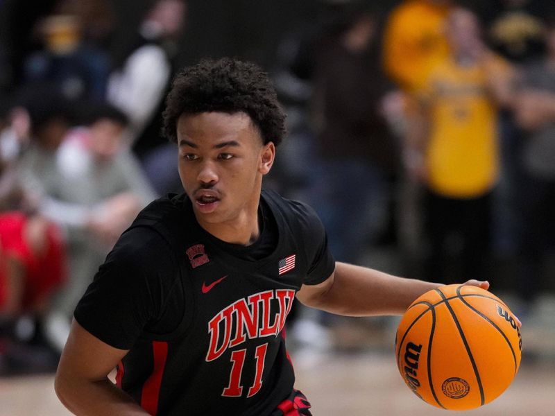 Feb 27, 2024; Laramie, Wyoming, USA; UNLV Runnin' Rebels guard Dedan Thomas Jr. (11) drives against the Wyoming Cowboys during the first half at Arena-Auditorium. Mandatory Credit: Troy Babbitt-USA TODAY Sports