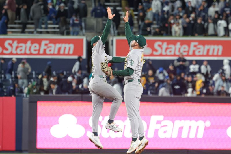 Apr 25, 2024; Bronx, New York, USA; Oakland Athletics third baseman Max Schuemann (12) celebrates with shortstop Nick Allen (10) after defeating the New York Yankees at Yankee Stadium. Mandatory Credit: Vincent Carchietta-USA TODAY Sports