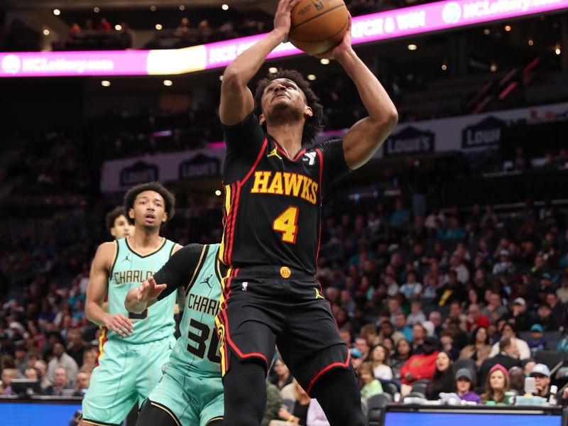 CHARLOTTE, NC - NOVEMBER 30: Kobe Bufkin #4 of the Atlanta Hawks drives to the basket during the game against the Charlotte Hornets on November 30, 2024 at Spectrum Center in Charlotte, North Carolina. NOTE TO USER: User expressly acknowledges and agrees that, by downloading and or using this photograph, User is consenting to the terms and conditions of the Getty Images License Agreement. Mandatory Copyright Notice: Copyright 2024 NBAE (Photo by Brock Williams-Smith/NBAE via Getty Images)