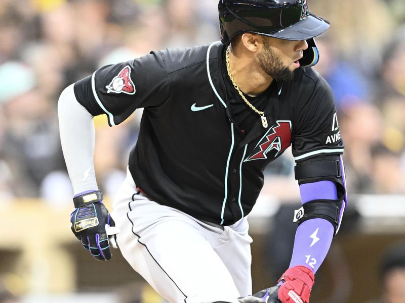 Jun 8, 2024; San Diego, California, USA;  Arizona Diamondbacks left fielder Lourdes Gurriel Jr. (12) hits a single during the fifth inning against the San Diego Padres at Petco Park. Mandatory Credit: Denis Poroy-USA TODAY Sports at Petco Park. 