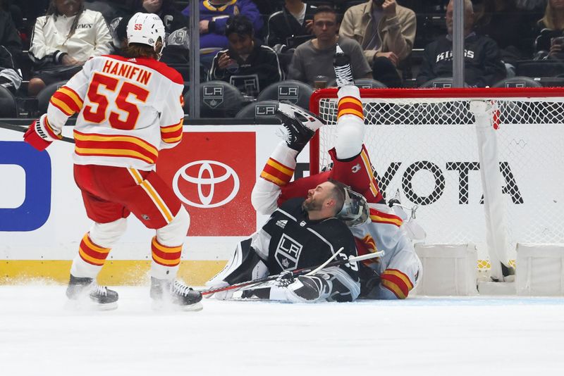 Dec 23, 2023; Los Angeles, California, USA; Calgary Flames center Blake Coleman (20) falls over Los Angeles Kings goaltender Cam Talbot (39) after scoring a goal during the second period of a game at Crypto.com Arena. Mandatory Credit: Jessica Alcheh-USA TODAY Sports