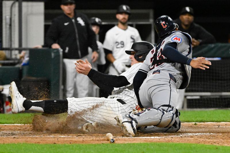 May 11, 2024; Chicago, Illinois, USA;  Chicago White Sox first base Andrew Vaughn (25) scores against Cleveland Guardians catcher Bo Naylor (23) during the eighth inning at Guaranteed Rate Field. Mandatory Credit: Matt Marton-USA TODAY Sports