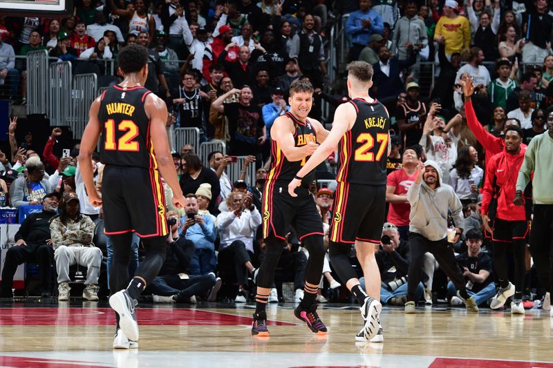 ATLANTA, GA - MARCH 28: Bogdan Bogdanovic #13 of the Atlanta Hawks celebrates after hitting the game tying shot during the game against the Boston Celtics on March 28, 2024 at State Farm Arena in Atlanta, Georgia.  NOTE TO USER: User expressly acknowledges and agrees that, by downloading and/or using this Photograph, user is consenting to the terms and conditions of the Getty Images License Agreement. Mandatory Copyright Notice: Copyright 2024 NBAE (Photo by Scott Cunningham/NBAE via Getty Images)