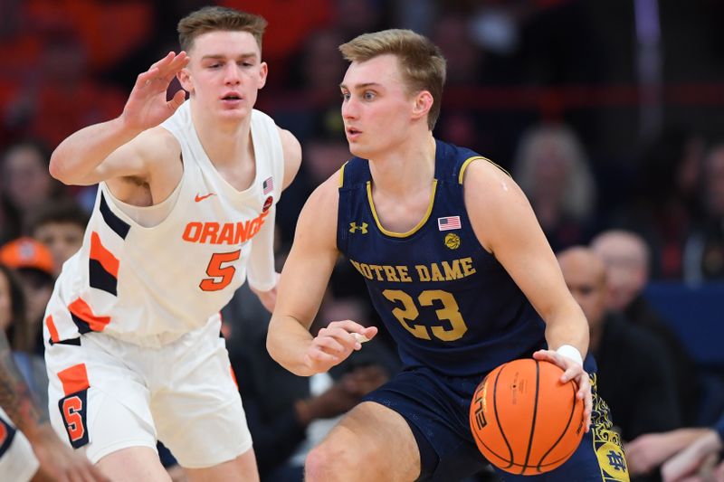 Jan 14, 2023; Syracuse, New York, USA; Notre Dame Fighting Irish guard Dane Goodwin (23) drives to the basket as Syracuse Orange guard Justin Taylor (5) defends during the first half at the JMA Wireless Dome. Mandatory Credit: Rich Barnes-USA TODAY Sports