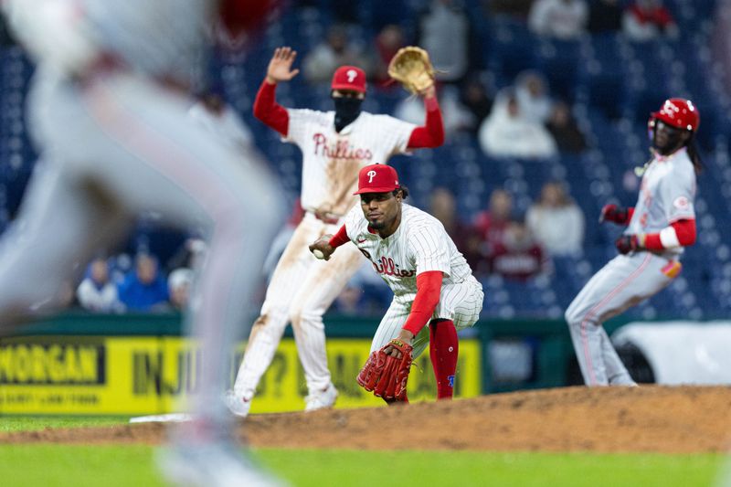 Apr 2, 2024; Philadelphia, Pennsylvania, USA; Philadelphia Phillies relief pitcher Ricardo Pinto (51) fields the RBI single of Cincinnati Reds left fielder Spencer Steer (7) during the ninth inning at Citizens Bank Park. Mandatory Credit: Bill Streicher-USA TODAY Sports