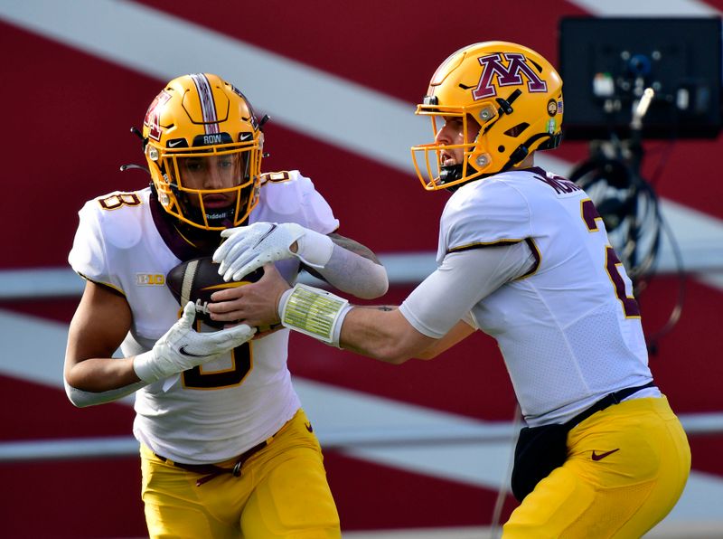 Nov 20, 2021; Bloomington, Indiana, USA;  Minnesota Golden Gophers quarterback Tanner Morgan (2) hands the ball off to Minnesota Golden Gophers running back Ky Thomas (8) during warmups before the game against the Indiana Hoosiers at Memorial Stadium. Mandatory Credit: Marc Lebryk-USA TODAY Sports