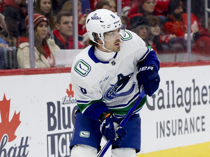 Dec 1, 2024; Detroit, Michigan, USA;  Vancouver Canucks right wing Conor Garland (8) skates with the puck in the third period against the Detroit Red Wings at Little Caesars Arena. Mandatory Credit: Rick Osentoski-Imagn Images