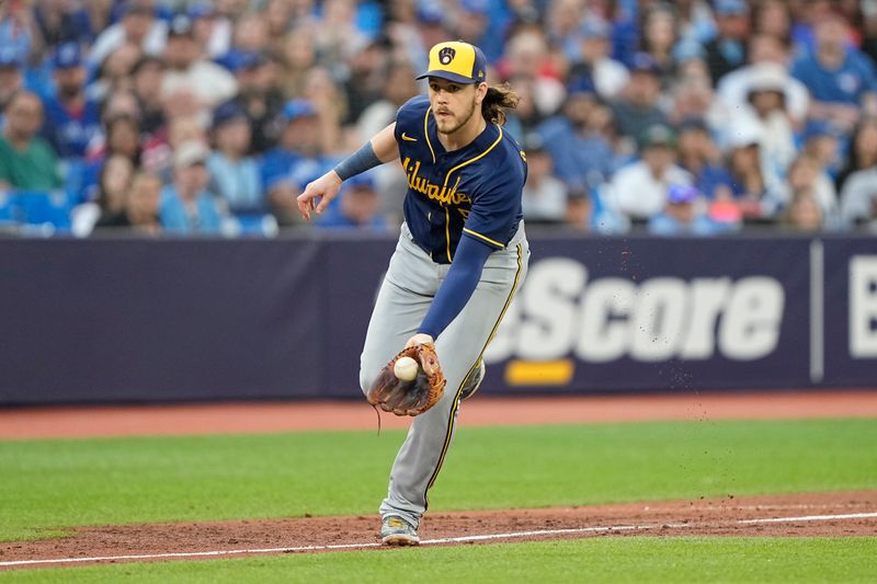 May 30, 2023; Toronto, Ontario, CAN; Milwaukee Brewers third baseman Brian Anderson (9) fields a ball hit by Toronto Blue Jays right fielder George Springer (not pictured) during the third inning at Rogers Centre. Mandatory Credit: John E. Sokolowski-USA TODAY Sports