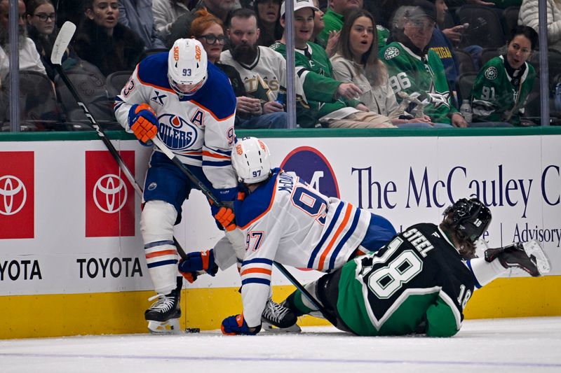 Mar 12, 2026; Dallas, Texas, USA; Edmonton Oilers center Connor McDavid (97) collides with center Ryan Nugent-Hopkins (93) and Dallas Stars center Sam Steel (18) during the first period at the American Airlines Center. Mandatory Credit: Jerome Miron-Imagn Images