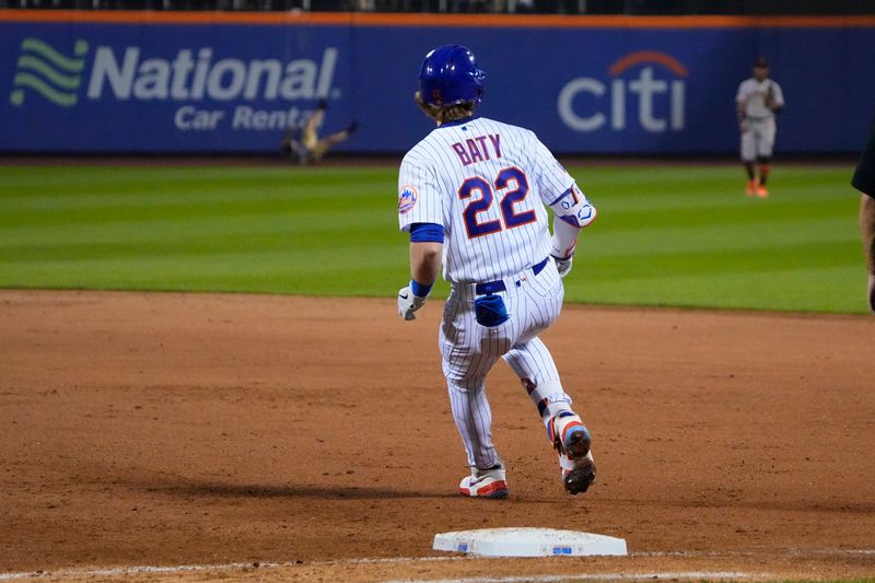 Jul 2, 2023; New York City, New York, USA; New York Mets third baseman Brett Baty (22) arrives a first with a fan falling out of the stands in the background during the fifth inning against the San Francisco Giants at Citi Field. Mandatory Credit: Gregory Fisher-USA TODAY Sports