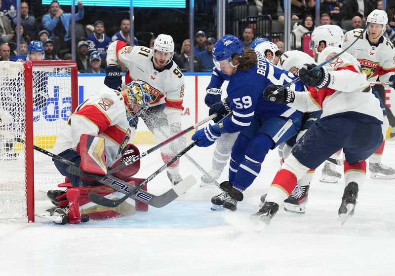 Nov 28, 2023; Toronto, Ontario, CAN; Toronto Maple Leafs left wing Tyler Bertuzzi (59) battles for the puck in front of Florida Panthers goaltender Anthony Stolarz (41) during the first period at Scotiabank Arena. Mandatory Credit: Nick Turchiaro-USA TODAY Sports