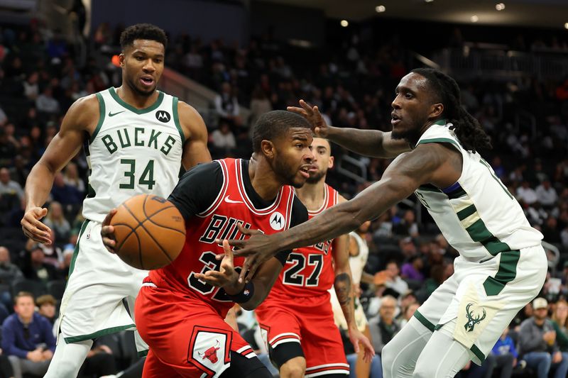 MILWAUKEE, WISCONSIN - OCTOBER 14: E.J. Liddell #32 of the Chicago Bulls is defended by Taurean Prince #12 of the Milwaukee Bucks during the second half of a preseason game at Fiserv Forum on October 14, 2024 in Milwaukee, Wisconsin.  NOTE TO USER: User expressly acknowledges and agrees that, by downloading and or using this photograph, User is consenting to the terms and conditions of the Getty Images License Agreement. (Photo by Stacy Revere/Getty Images)