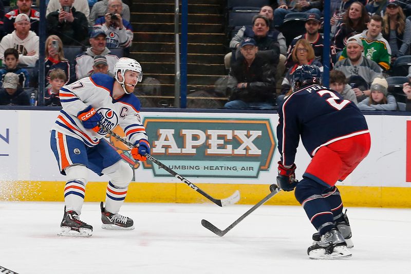 Mar 7, 2024; Columbus, Ohio, USA; Columbus Blue Jackets defenseman Andrew Peeke (2) blocks the shot attempt of Edmonton Oilers center Connor McDavid (97) during the third period at Nationwide Arena. Mandatory Credit: Russell LaBounty-USA TODAY Sports