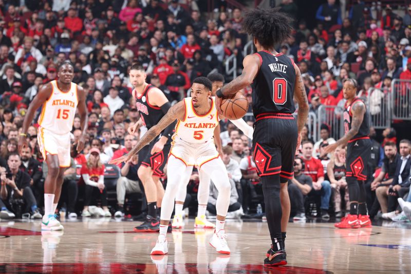 CHICAGO, IL - APRIL 17:  Dejounte Murray #5 of the Atlanta Hawks plays defense during the game  against Coby White #0 of the Chicago Bulls during the 2024 Play-In Tournament  on April 17, 2024 at United Center in Chicago, Illinois. NOTE TO USER: User expressly acknowledges and agrees that, by downloading and or using this photograph, User is consenting to the terms and conditions of the Getty Images License Agreement. Mandatory Copyright Notice: Copyright 2024 NBAE (Photo by Jeff Haynes/NBAE via Getty Images)