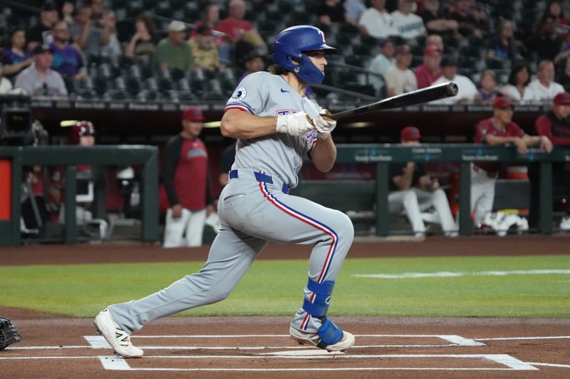 Sep 3, 2025; Phoenix, Arizona, USA; Texas Rangers shortstop Josh Smith (8) hits a single against the Arizona Diamondbacks in the first inning at Chase Field. Mandatory Credit: Rick Scuteri-Imagn Images