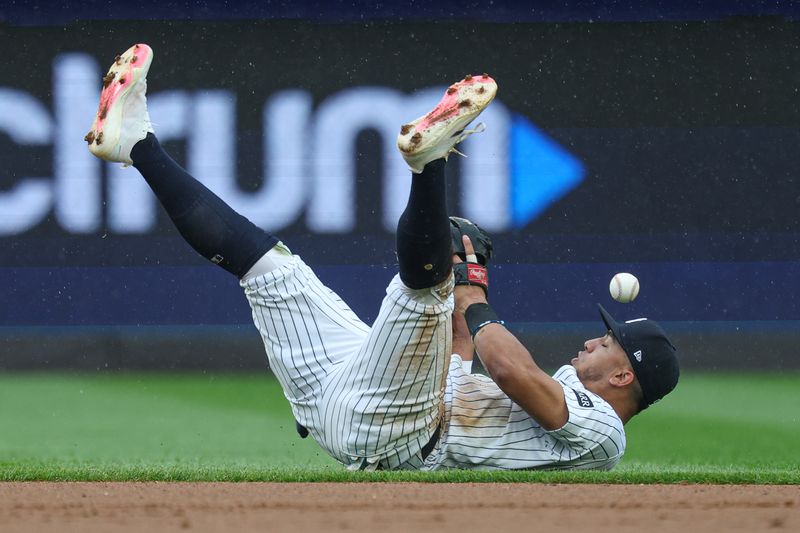 May 4, 2025; Bronx, New York, USA; New York Yankees third baseman Oswald Peraza (18) fields but can not secure an infield single by Tampa Bay Rays first baseman Yandy Diaz (not pictured) during the fourth inning at Yankee Stadium. Mandatory Credit: Vincent Carchietta-Imagn Images