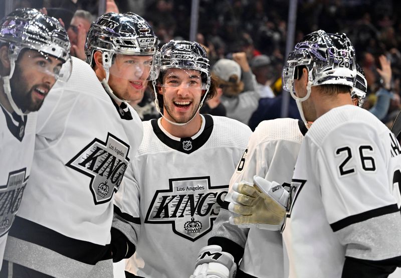 Apr 10, 2023; Los Angeles, California, USA;  Los Angeles Kings right wing Arthur Kaliyev (34), second from left, celebrates after scoring a goal in the second period against the Vancouver Canucks at Crypto.com Arena. Mandatory Credit: Jayne Kamin-Oncea-USA TODAY Sports