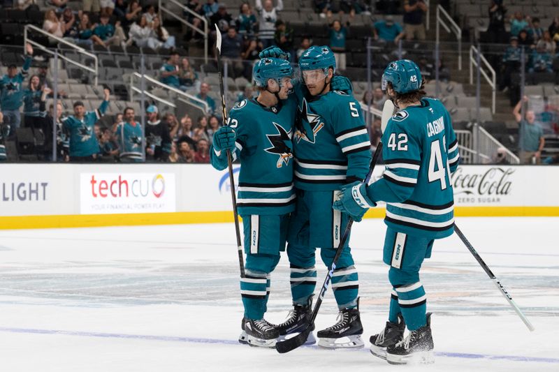 Oct 1, 2024; San Jose, California, USA;  San Jose Sharks defenseman Matt Benning (5) gets congratulated by his teammates after scoring a goal during the second period against the Utah Hockey Club at SAP Center at San Jose. Mandatory Credit: Stan Szeto-Imagn Images
