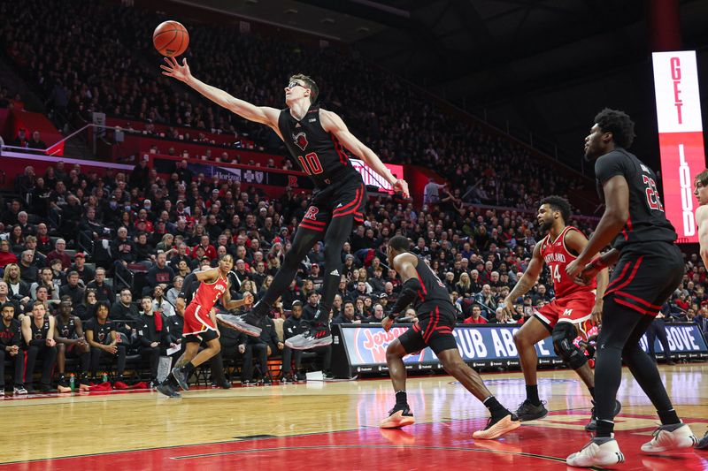 Feb 25, 2024; Piscataway, New Jersey, USA; Rutgers Scarlet Knights guard Gavin Griffiths (10) rebounds in front of Maryland Terrapins forward Mady Traore (14) during the first half at Jersey Mike's Arena. Mandatory Credit: Vincent Carchietta-USA TODAY Sports