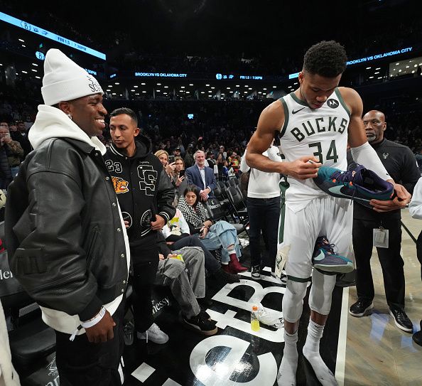 BROOKLYN, NY - DECEMBER 27: Vinicius Junior greets Giannis Antetokounmpo #34 of the Milwaukee Bucks after the game against the Brooklyn Nets on December 27, 2023 at Barclays Center in Brooklyn, New York. NOTE TO USER: User expressly acknowledges and agrees that, by downloading and or using this Photograph, user is consenting to the terms and conditions of the Getty Images License Agreement. Mandatory Copyright Notice: Copyright 2023 NBAE (Photo by Jesse D. Garrabrant/NBAE via Getty Images)