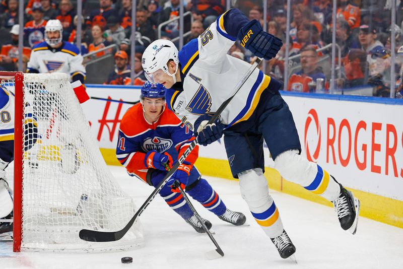 Feb 28, 2024; Edmonton, Alberta, CAN; St. Louis Blues defensemen Colton Parayko (55) moves the puck in front of Edmonton Oilers forward Ryan McLeod (71) during the first period at Rogers Place. Mandatory Credit: Perry Nelson-USA TODAY Sports