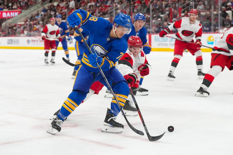 Nov 8, 2025; Raleigh, North Carolina, USA;  Buffalo Sabres defenseman Jacob Bryson (78) skates with the puck past Carolina Hurricanes defenseman Mike Reilly (6) during the second period at Lenovo Center. Mandatory Credit: James Guillory-Imagn Images