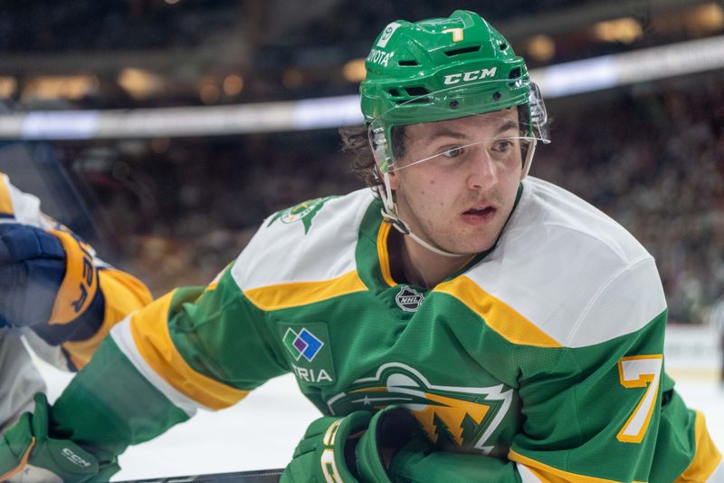 Dec 31, 2024; Saint Paul, Minnesota, USA; Minnesota Wild defenseman Brock Faber (7) plays along the boards against the Nashville Predators in the third period at Xcel Energy Center. Mandatory Credit: Matt Blewett-Imagn Images