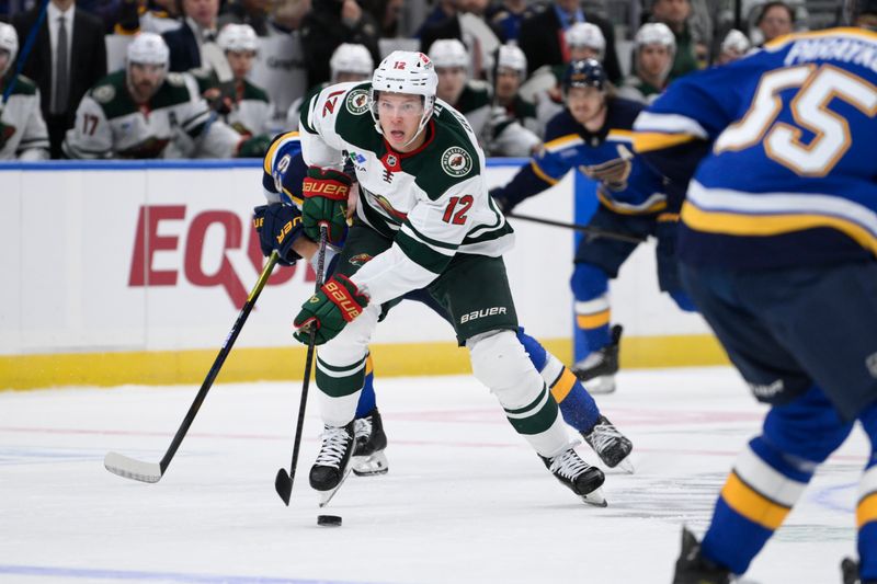 Oct 15, 2024; St. Louis, Missouri, USA; St. Louis Blues center Radek Faksa (12) controls the puck against the St. Louis Blues during the first period at Enterprise Center. Mandatory Credit: Jeff Le-Imagn Images